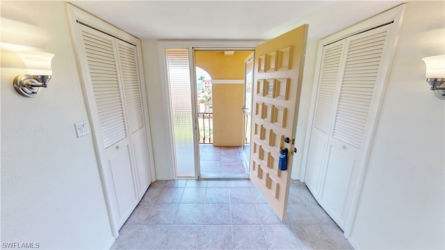 hall featuring light tile floors