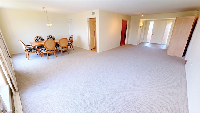 dining room with light carpet