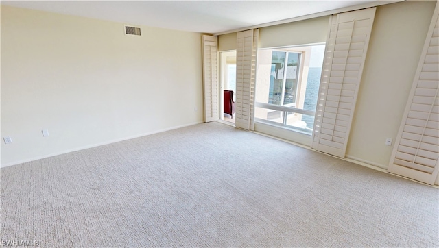 empty room featuring light colored carpet