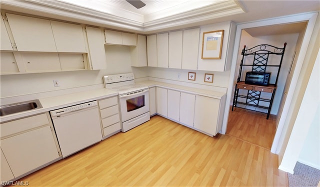 kitchen featuring white appliances, ceiling fan, ornamental molding, light hardwood / wood-style floors, and a tray ceiling