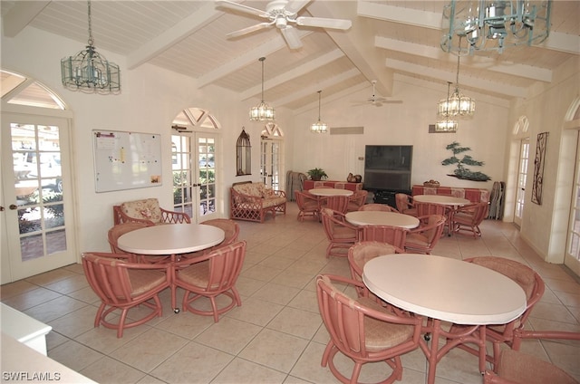 tiled dining area with beam ceiling, high vaulted ceiling, and ceiling fan with notable chandelier