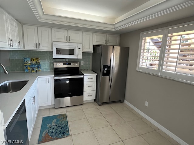 kitchen with white cabinets, a raised ceiling, sink, and appliances with stainless steel finishes