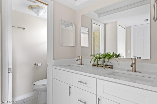 bathroom featuring tile patterned flooring, vanity, toilet, and crown molding