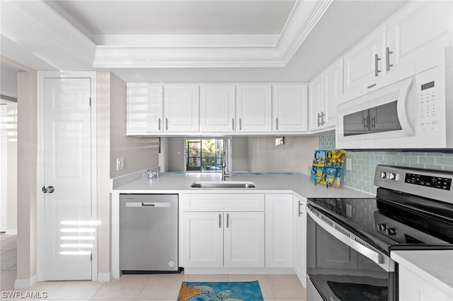 kitchen with white cabinetry, sink, light tile patterned floors, and stainless steel appliances