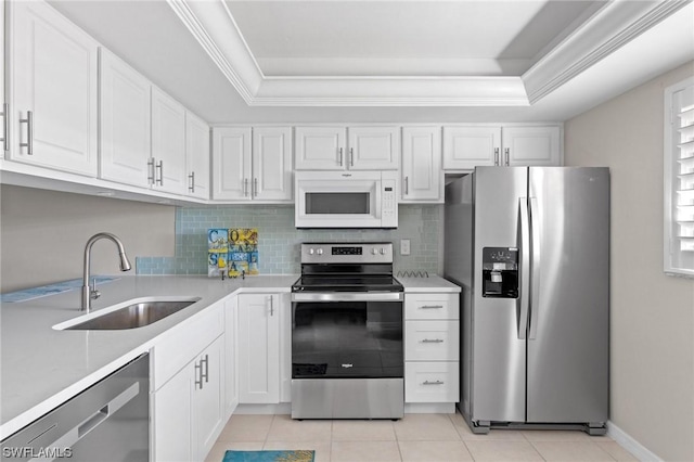 kitchen with white cabinetry, sink, light tile patterned floors, and appliances with stainless steel finishes