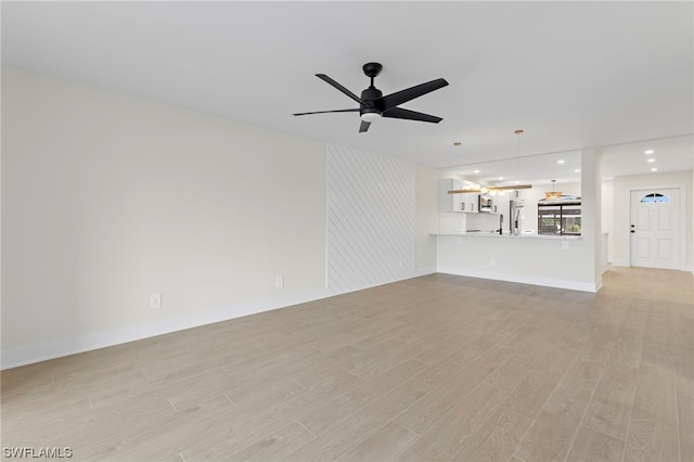 unfurnished living room featuring light hardwood / wood-style floors and ceiling fan