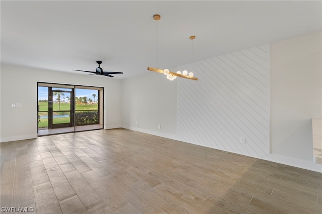 spare room featuring light hardwood / wood-style floors and ceiling fan