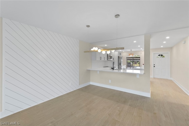 unfurnished living room with light hardwood / wood-style floors