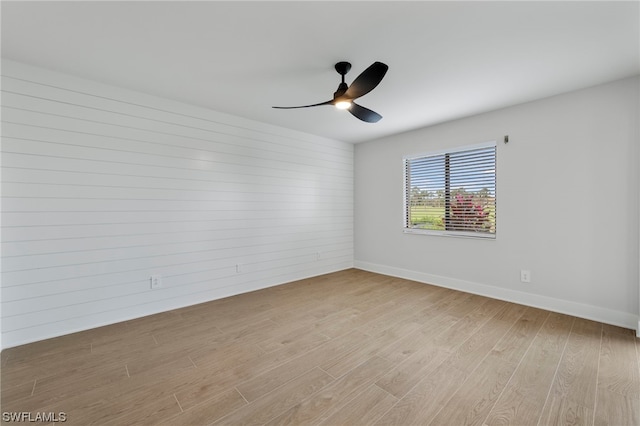 unfurnished room with ceiling fan and light wood-type flooring