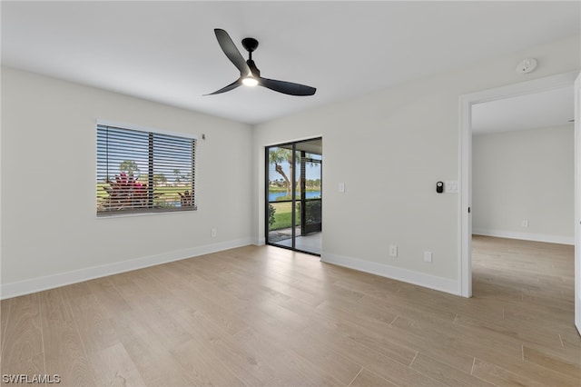 spare room with light hardwood / wood-style floors and ceiling fan