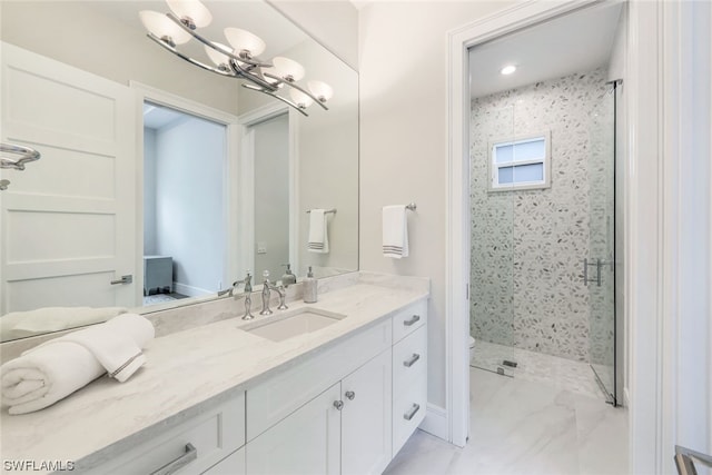 bathroom featuring a chandelier, tile floors, a shower with shower door, and vanity