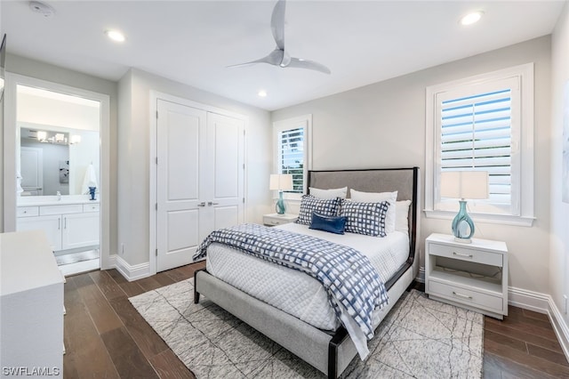 bedroom featuring dark hardwood / wood-style flooring, a closet, ceiling fan, and multiple windows