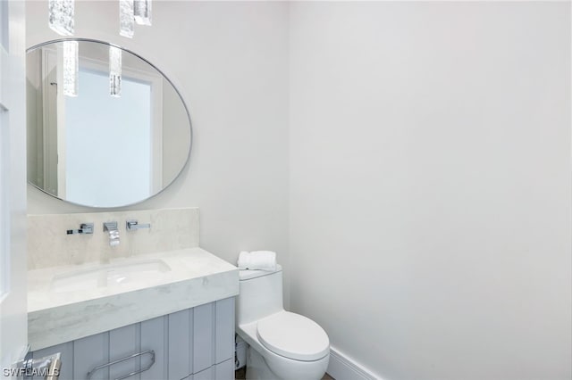 bathroom with toilet and large vanity