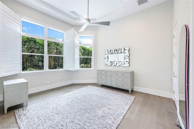 bedroom with multiple windows, ceiling fan, and light wood-type flooring