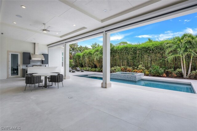 view of patio / terrace with a swimming pool with hot tub and ceiling fan