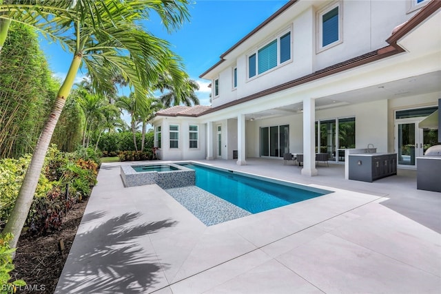 view of pool with a patio, area for grilling, an in ground hot tub, and a grill