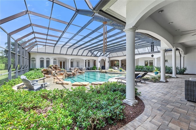 view of swimming pool with a patio area and glass enclosure