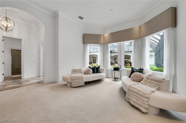 sitting room with ornamental molding, light colored carpet, and a chandelier