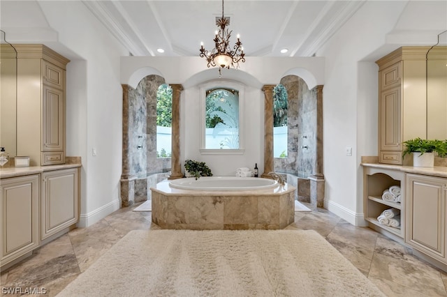 bathroom with vanity, a bathing tub, ornate columns, and an inviting chandelier