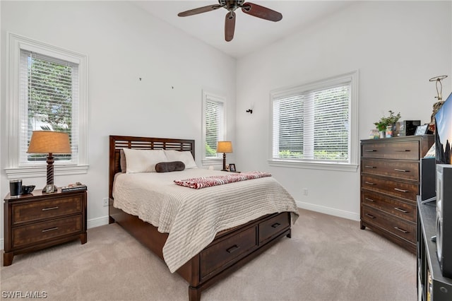 bedroom with light colored carpet and ceiling fan