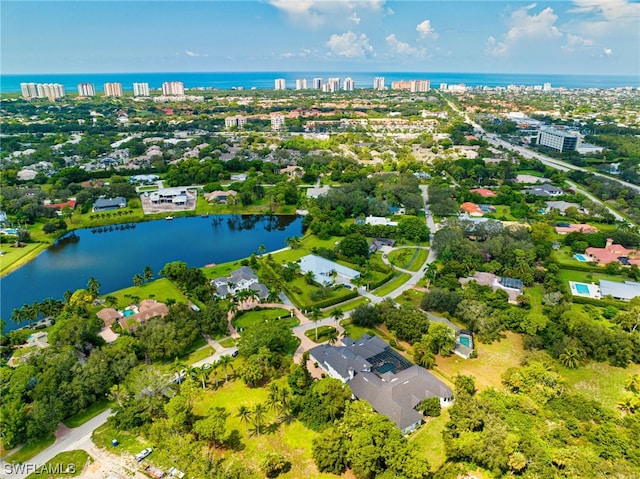 birds eye view of property with a water view
