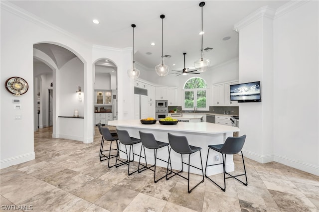 kitchen with built in appliances, hanging light fixtures, ceiling fan, and light tile floors