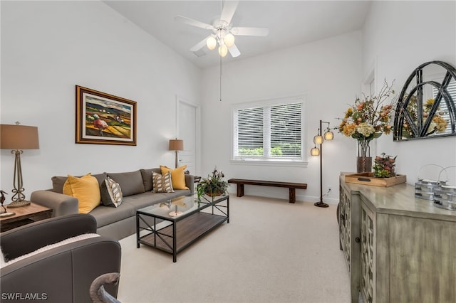 carpeted living room featuring ceiling fan and high vaulted ceiling