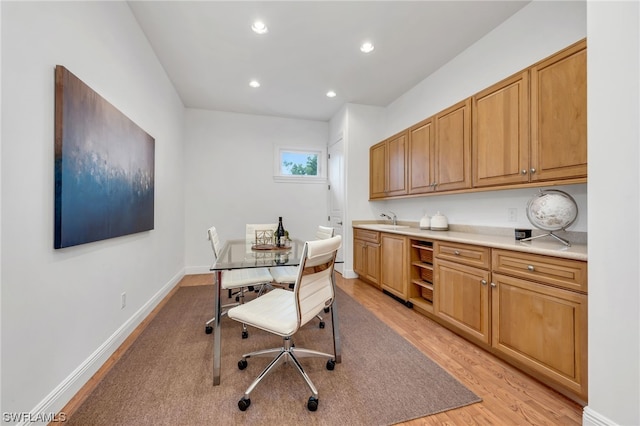 office featuring light hardwood / wood-style floors and sink
