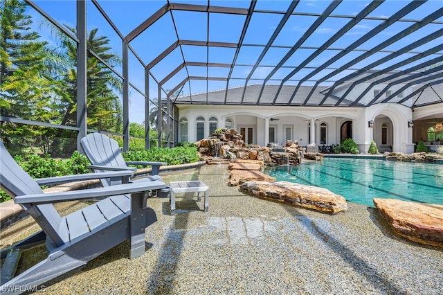 view of swimming pool featuring a patio area and glass enclosure