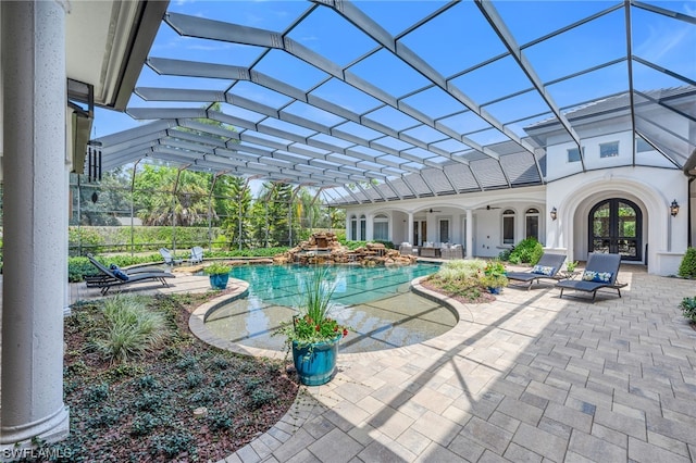 view of pool with french doors, glass enclosure, and a patio