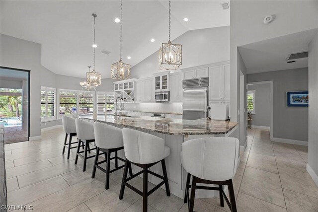 kitchen featuring a sink, white cabinetry, appliances with stainless steel finishes, and an inviting chandelier