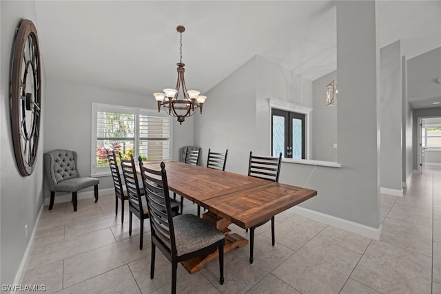 tiled dining space with a notable chandelier and french doors