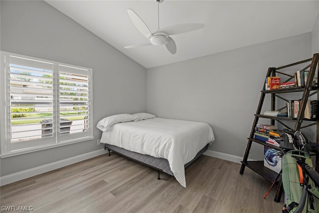 bedroom featuring ceiling fan, light hardwood / wood-style flooring, and vaulted ceiling