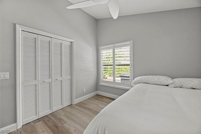 bedroom with a closet, a ceiling fan, baseboards, and wood finished floors