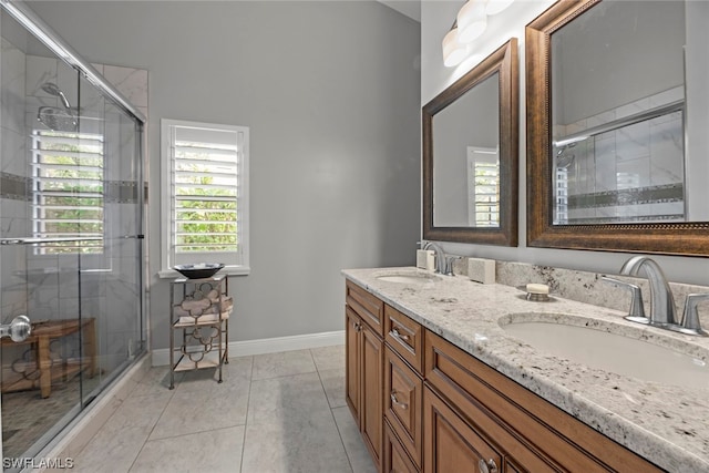 bathroom featuring vanity, a shower with shower door, and tile patterned flooring