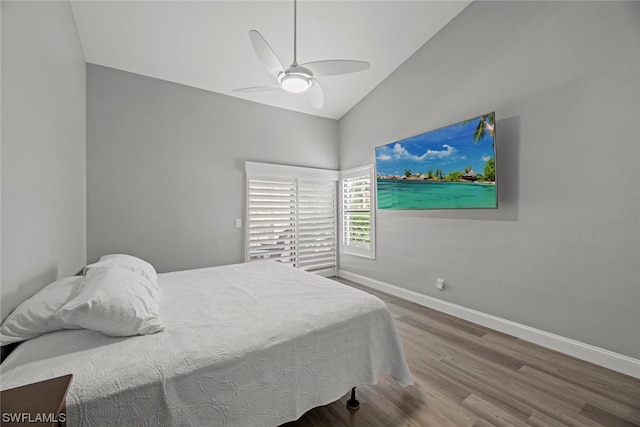 bedroom with hardwood / wood-style floors, vaulted ceiling, and ceiling fan