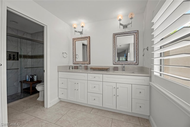 bathroom featuring vanity, toilet, an enclosed shower, and tile patterned flooring