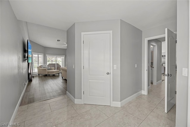 corridor with light tile patterned flooring