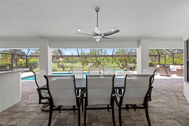 view of patio / terrace with ceiling fan, a lanai, outdoor lounge area, outdoor dining space, and an outdoor pool