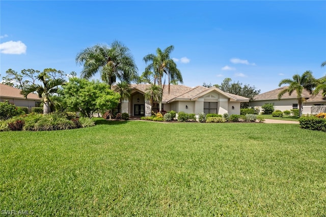 view of front of house with stucco siding and a front lawn