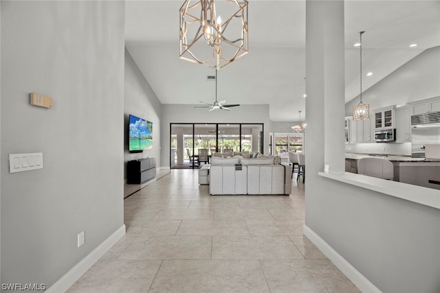 hall featuring light tile patterned floors, baseboards, high vaulted ceiling, recessed lighting, and a chandelier