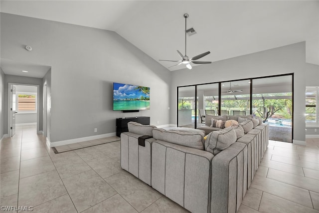 living room featuring ceiling fan, light tile patterned floors, and lofted ceiling