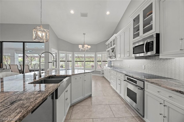 kitchen with backsplash, visible vents, appliances with stainless steel finishes, and a chandelier