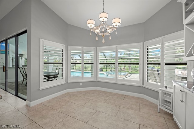 unfurnished dining area featuring vaulted ceiling, light tile patterned floors, and a notable chandelier