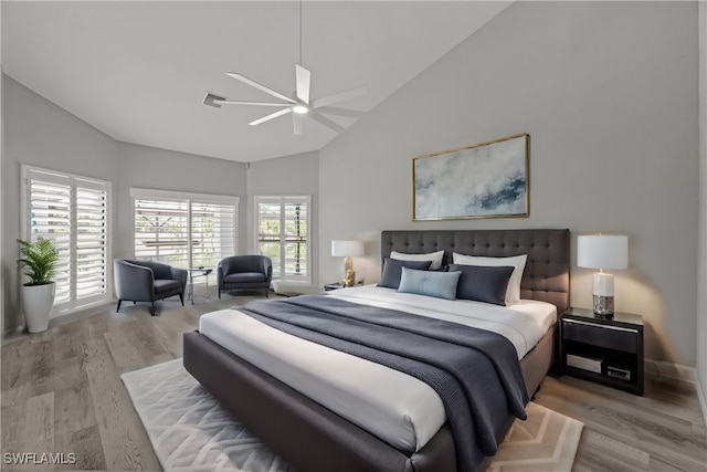 bedroom with lofted ceiling, light hardwood / wood-style flooring, and ceiling fan