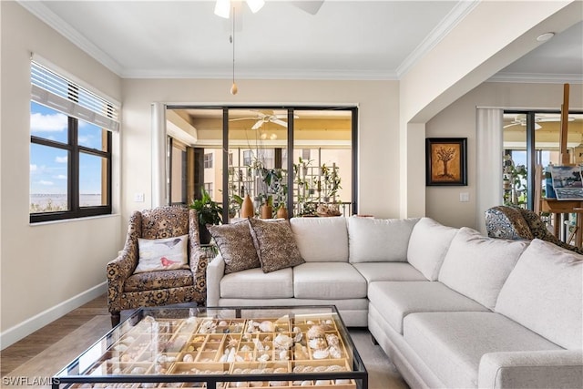 living room featuring ornamental molding, hardwood / wood-style floors, and ceiling fan