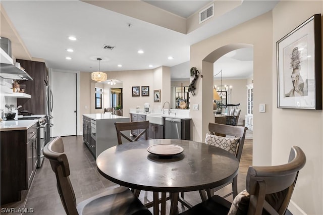 dining room with sink and a chandelier