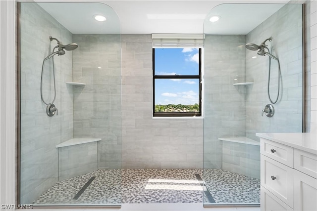 bathroom featuring vanity and a tile shower