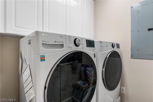 clothes washing area with separate washer and dryer, electric panel, and cabinets