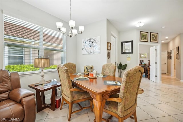 tiled dining area featuring an inviting chandelier